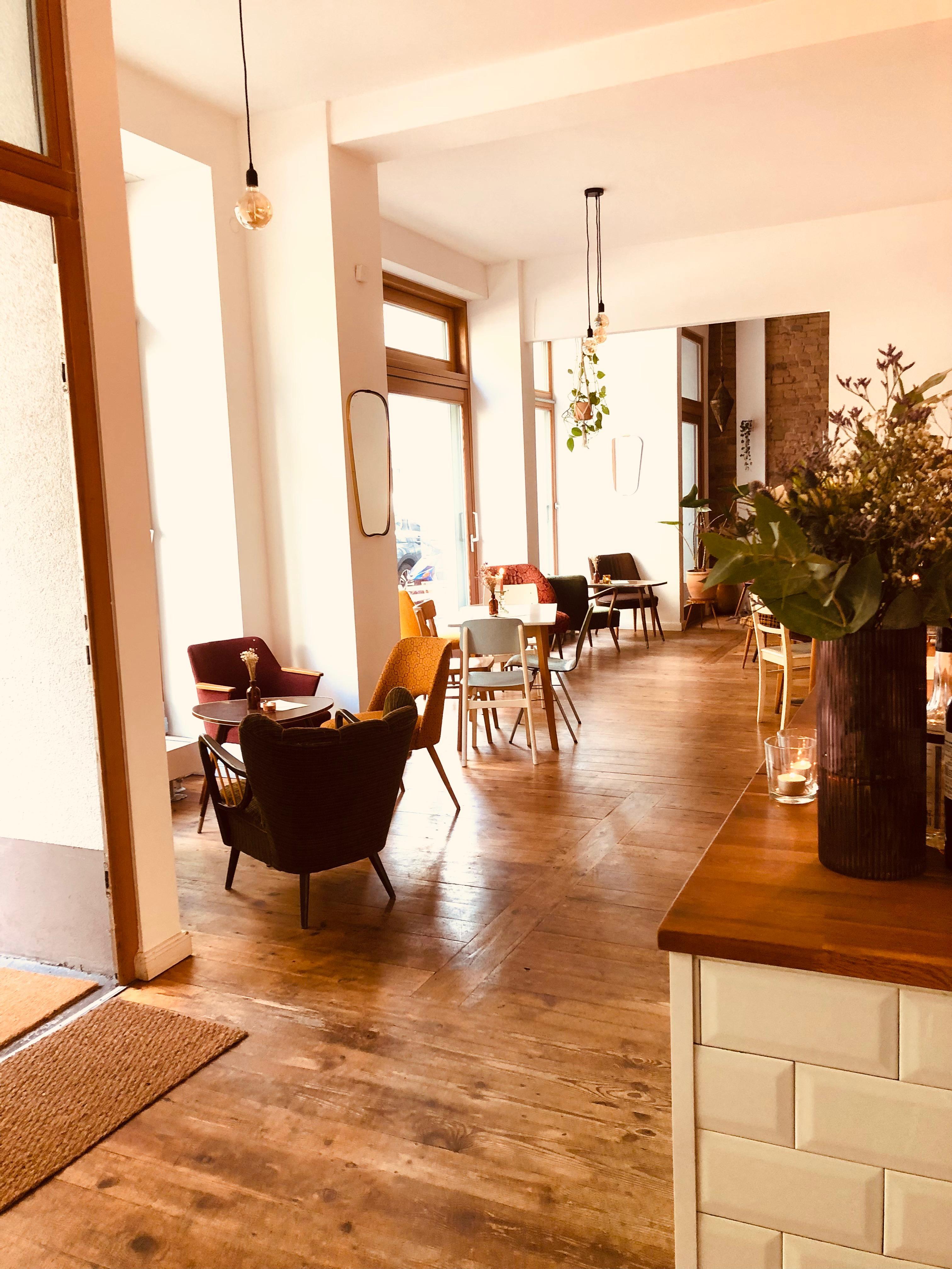 Innenraum des Café Zeitouna mit Holzboden und gemütlicher Bestuhlung